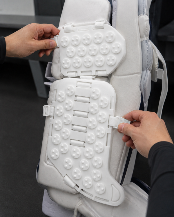 rollie goalie sliders being positioned on goalie pads for optimal performance